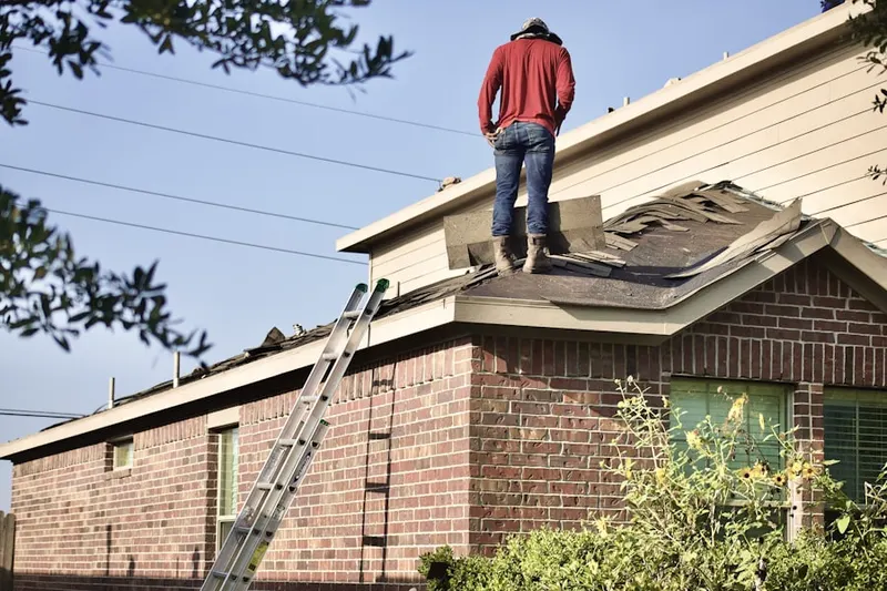 Professional roofer working on a residential roof in Woburn